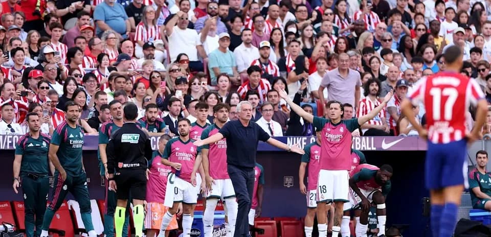 Coaches and players on sidelines during match