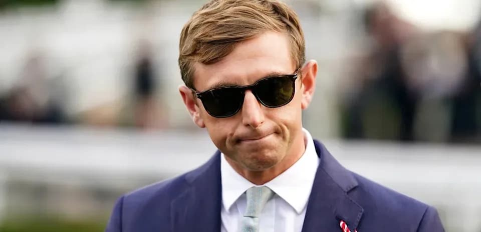 Man in sunglasses wearing a suit outdoors