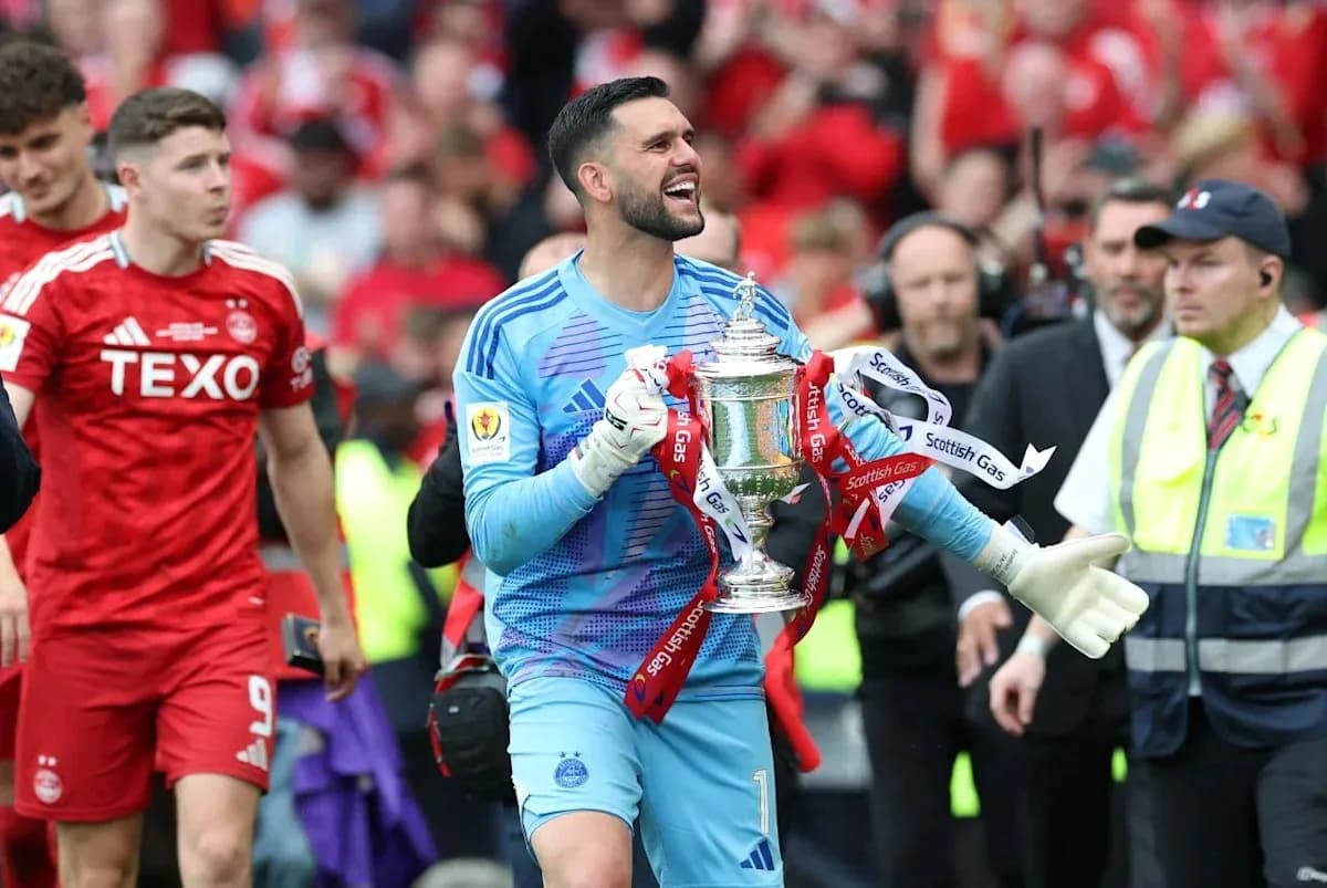 Goalkeeper celebrating with trophy after match victory