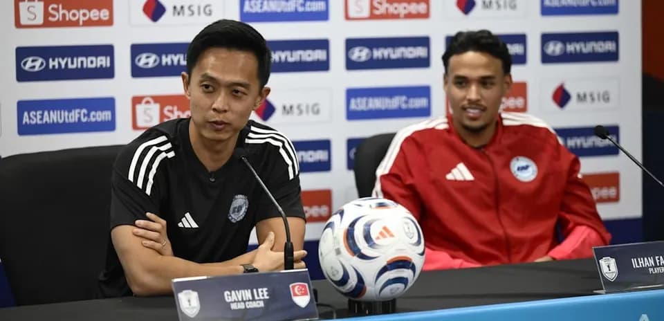 Head coach and player at press conference table