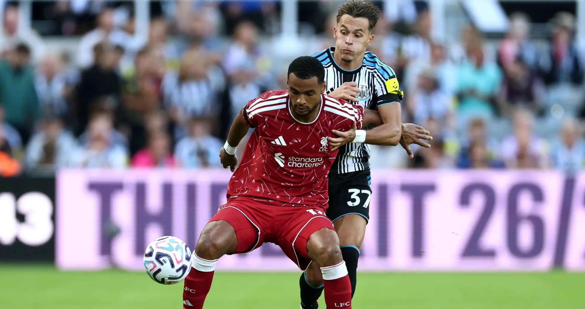Liverpool player challenged by Newcastle defender during match