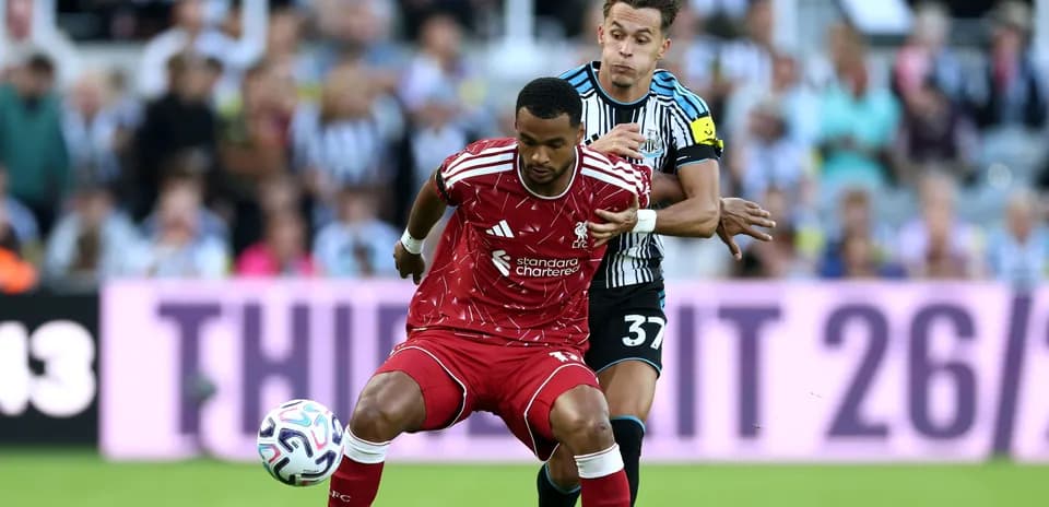 Liverpool player challenged by Newcastle defender during match