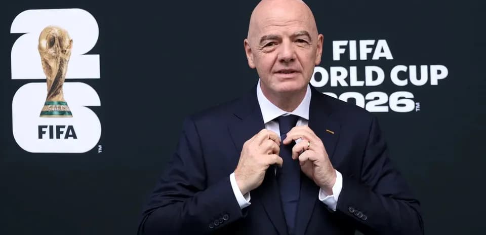 FIFA president adjusting tie before World Cup event