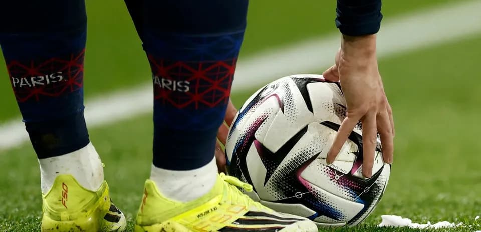 Player placing ball on pitch for set piece