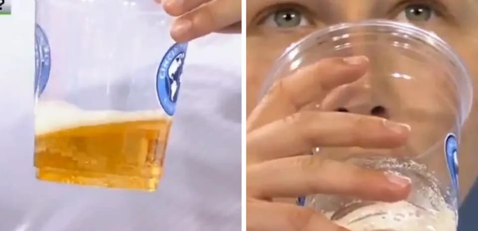 Kishi shisha ichida pivo ko'tarilgan qo'l