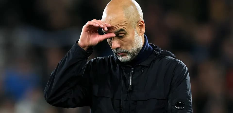 Football manager looking down during match