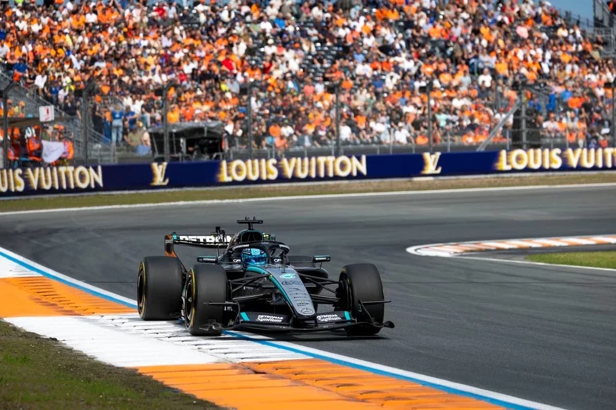 Formula 1 car racing on track with spectators