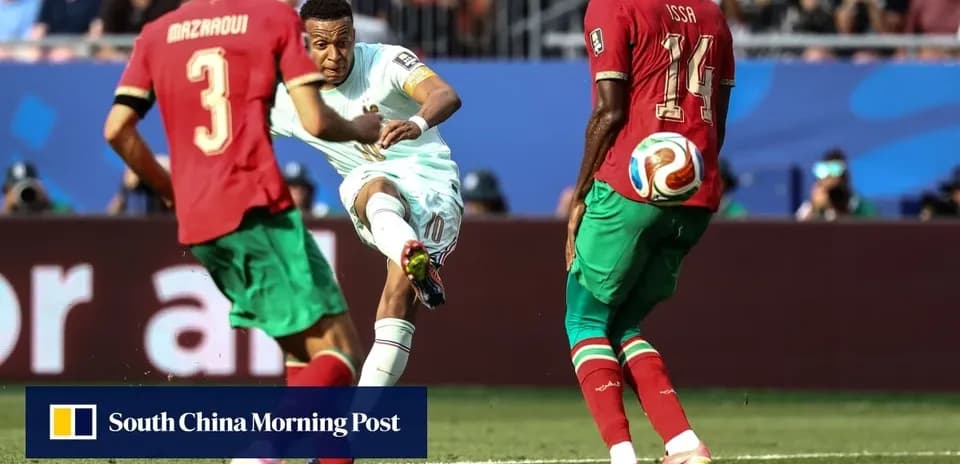 Player kicking ball while defenders attempt to block