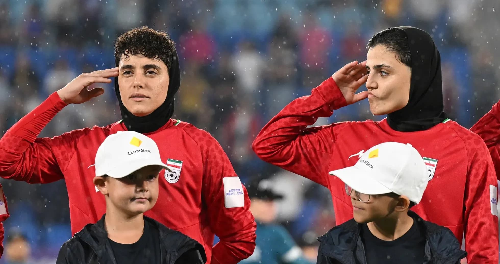 Football players saluting during national anthem ceremony