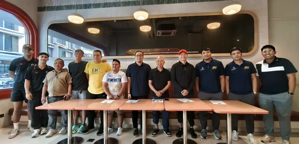 Group of men posing together in a restaurant