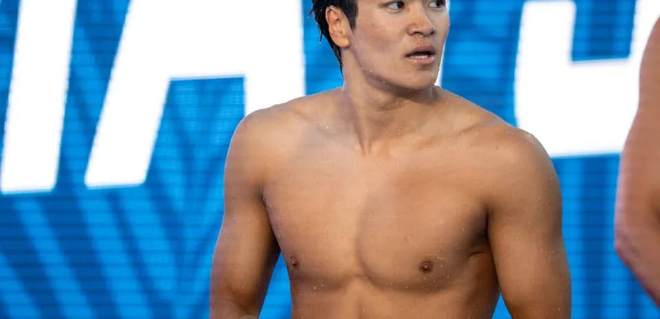 Yoshida standing on poolside before competition