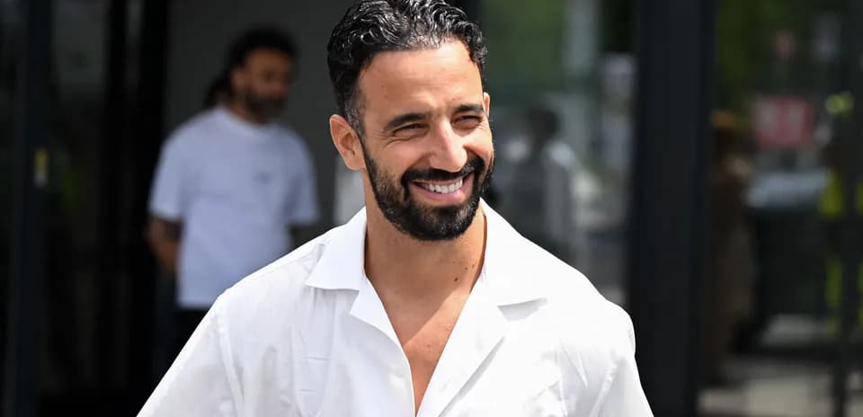 Football player smiling while walking outdoors