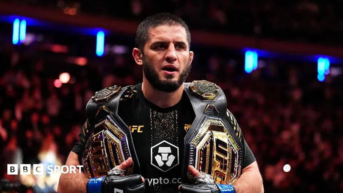 Fighter holding two championship belts after victory Fighter holding two championship belts after victory