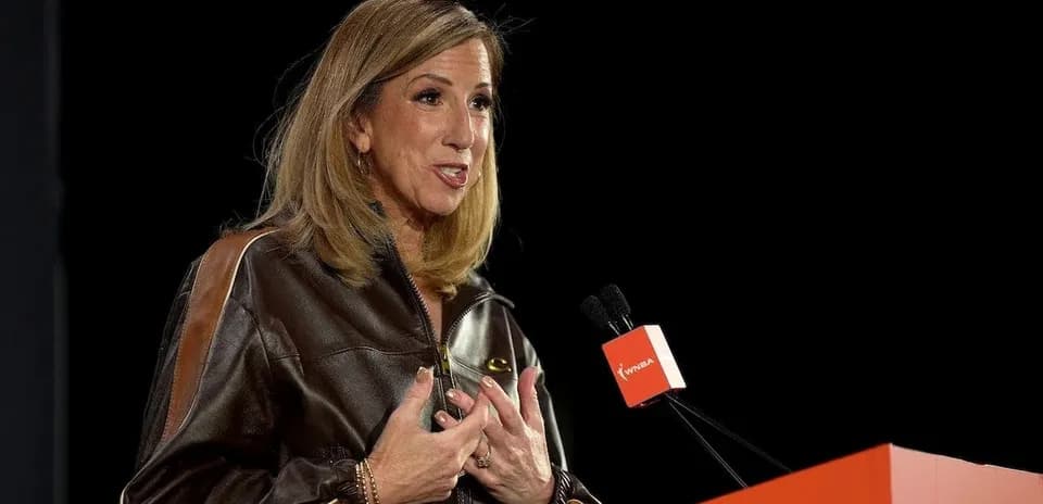 Speaker addressing audience at WNBA event podium