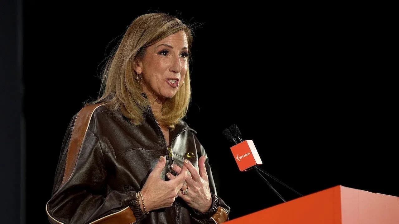 Speaker addressing audience at WNBA event podium