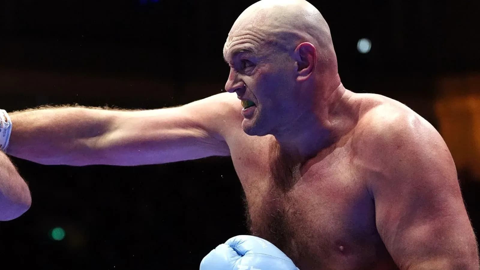 Boxer throwing a punch during a match Boxer throwing a punch during a match