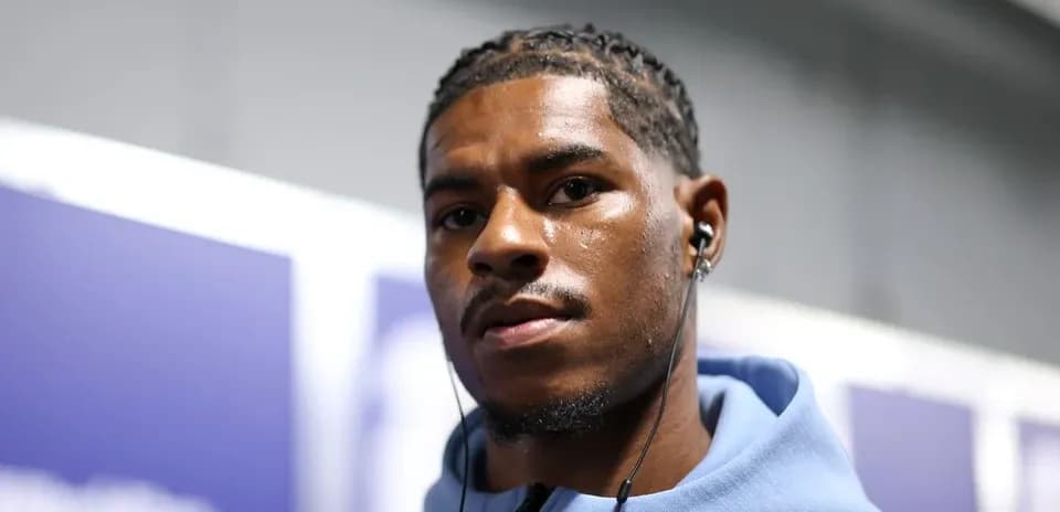 Athlete wearing headphones in a corridor