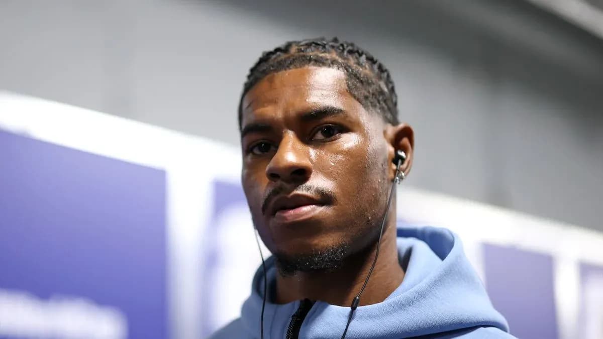 Athlete wearing headphones in a corridor