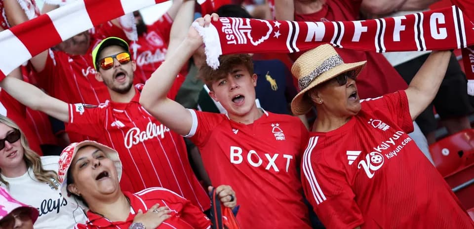 Fans celebrating and cheering in Nottingham Forest jerseys