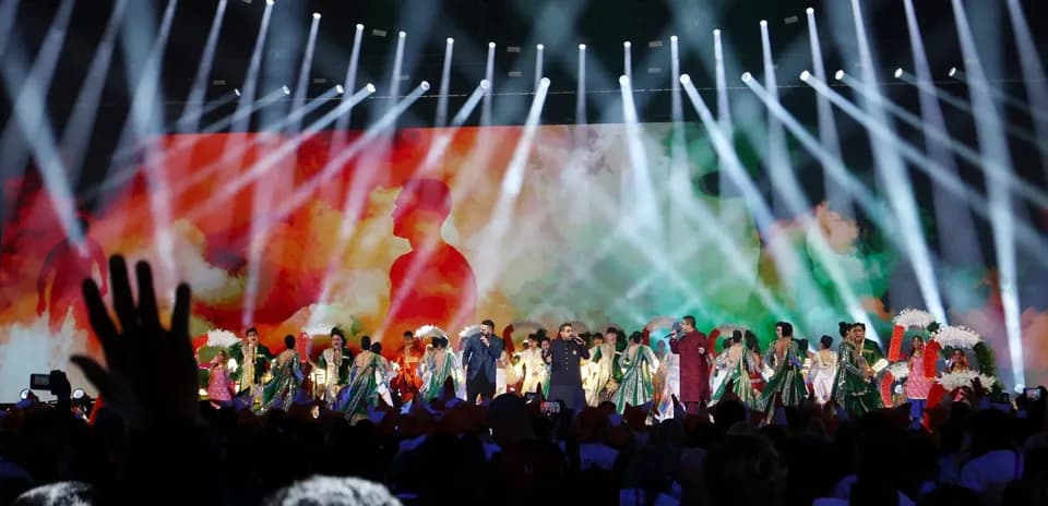 Performers on stage during a colorful event