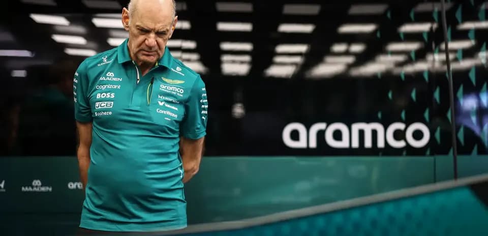 Aston Martin team member looking down in garage