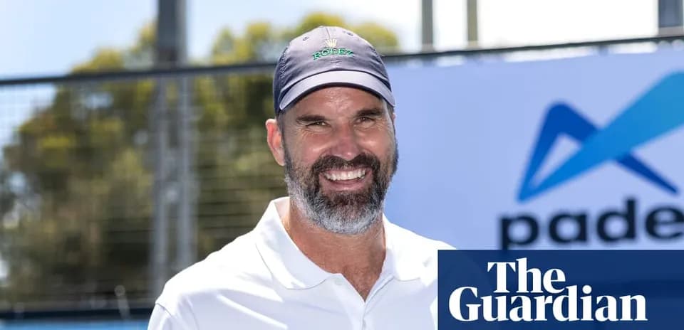 Tennis coach smiling at padel event outdoors