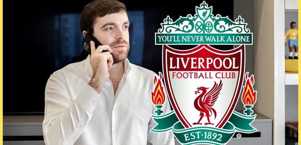 Man speaking on phone with Liverpool FC logo