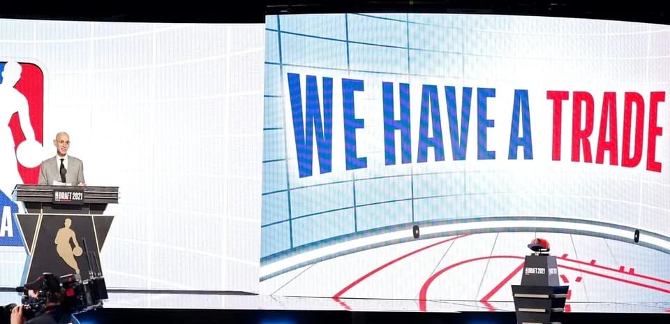 NBA official announcing trade at draft event