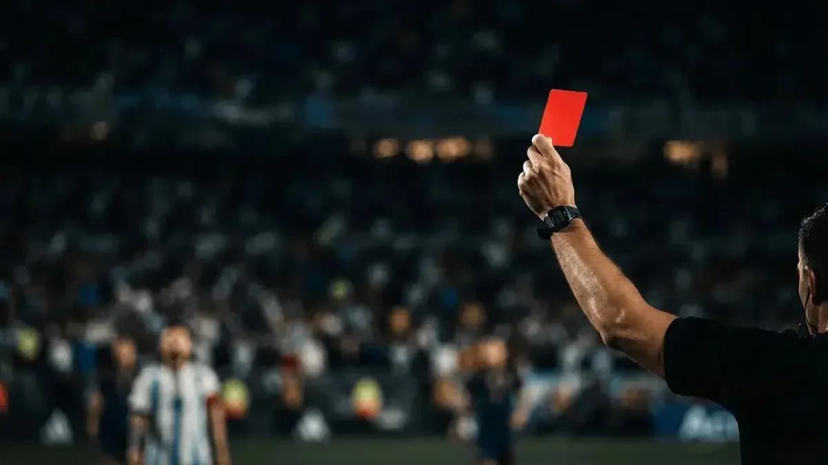 Referee showing red card during football match