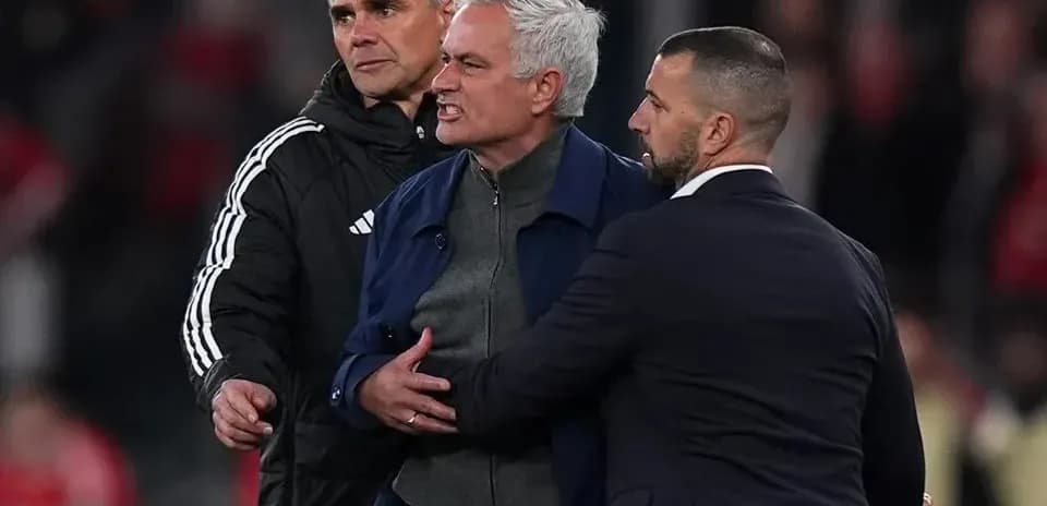 Mourinho being restrained by staff during match