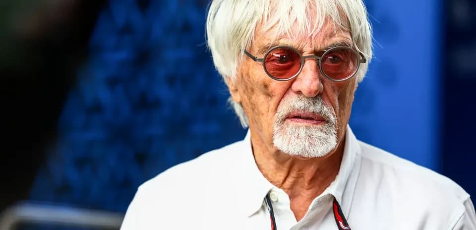 Man with white hair and sunglasses in casual attire