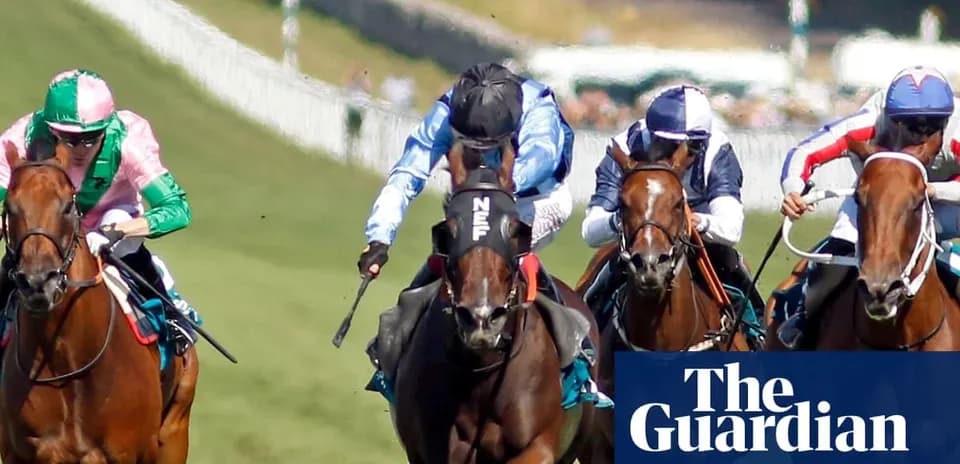 Jockeys racing on horses during horse race
