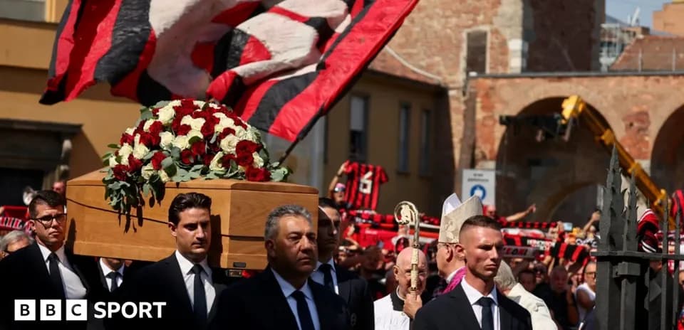 Coffin carried during memorial procession with fans