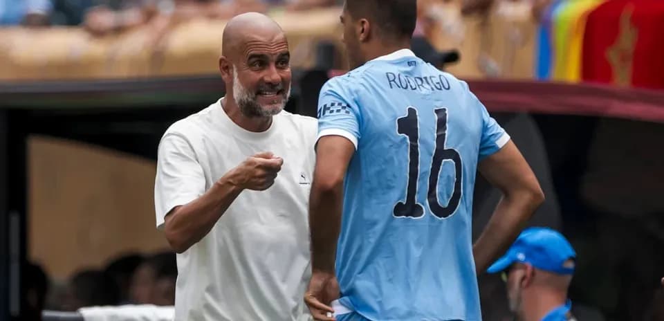 Pep Guardiola discussing strategy with Rodrigo during match