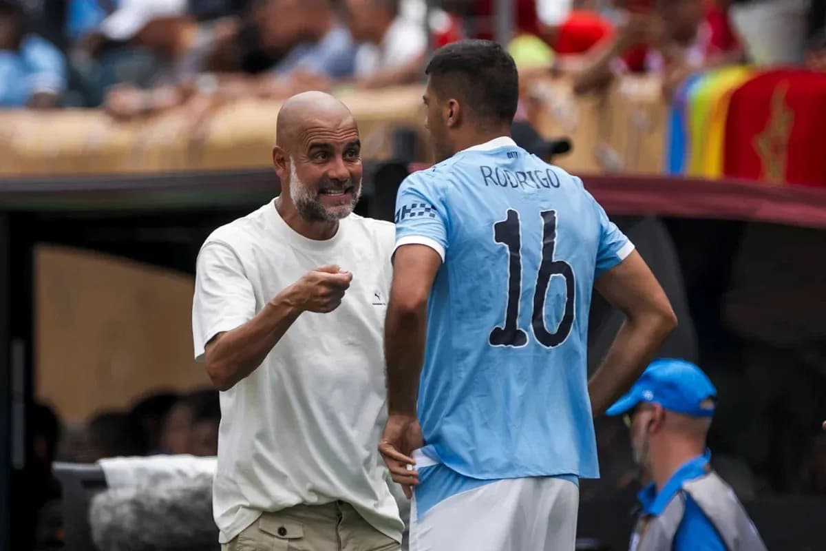 Pep Guardiola discussing strategy with Rodrigo during match