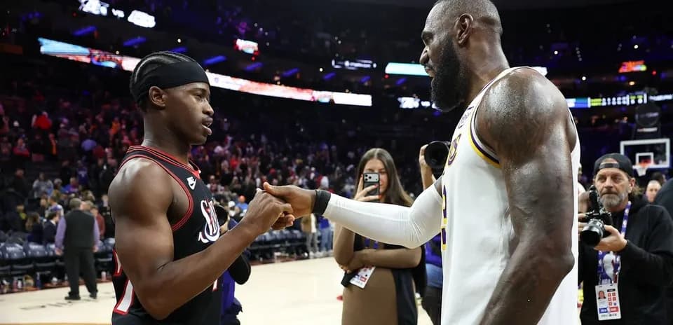Two basketball players shaking hands after game