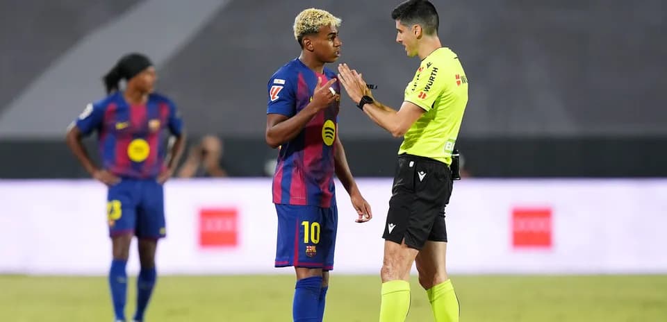 Barcelona player discussing with referee during match