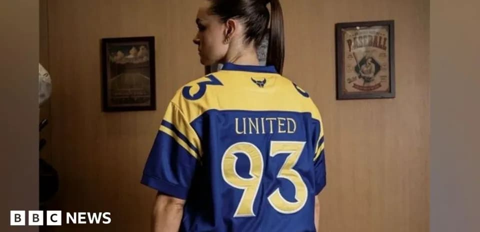 Player wearing blue and yellow jersey with 'United 93'