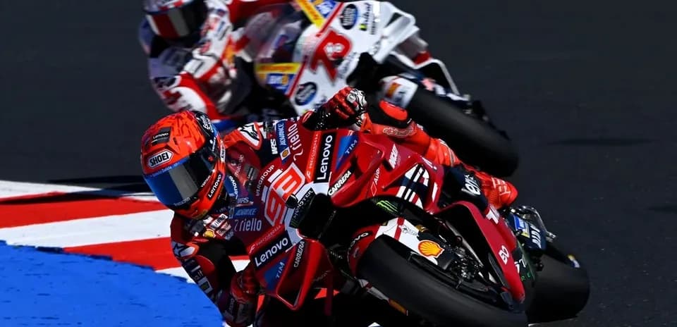 Ducati rider cornering with another racer behind