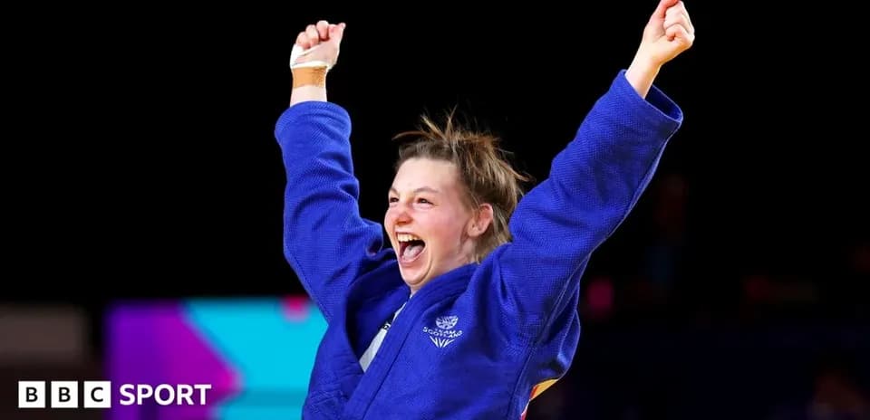 Judoka celebrating victory with raised arms