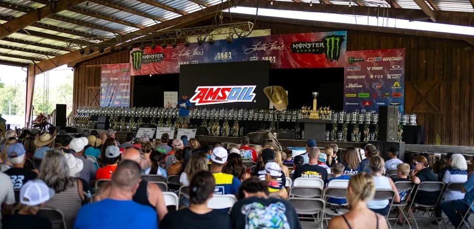Audience at awards ceremony with trophies on stage