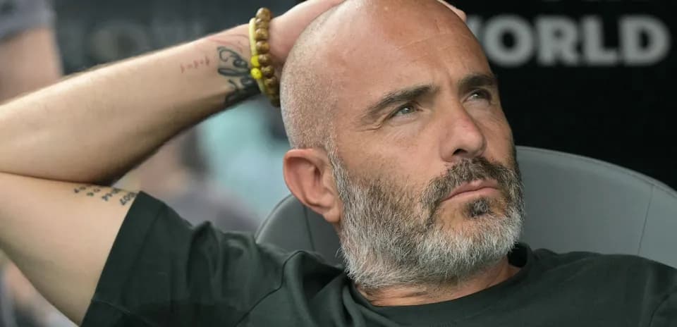Bald man with beard resting during match