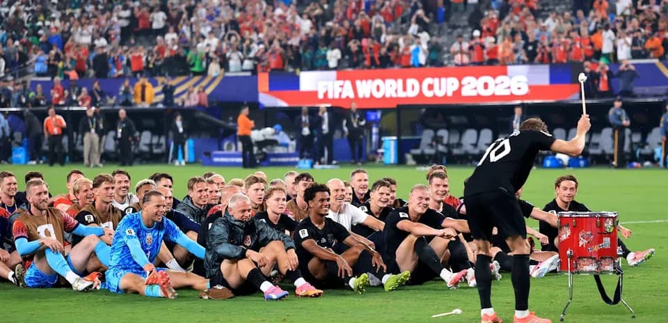 Football team celebrating on the field after match
