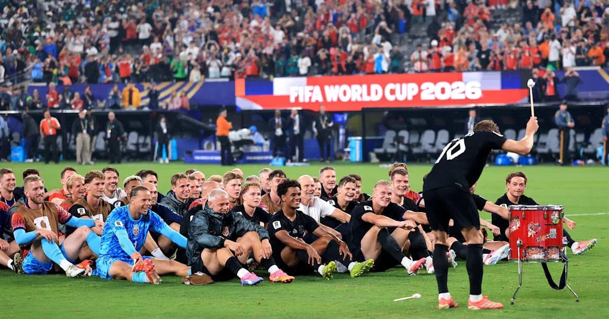 Football team celebrating on the field after match