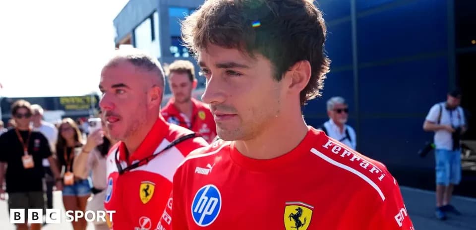 Ferrari team members walking in the paddock area