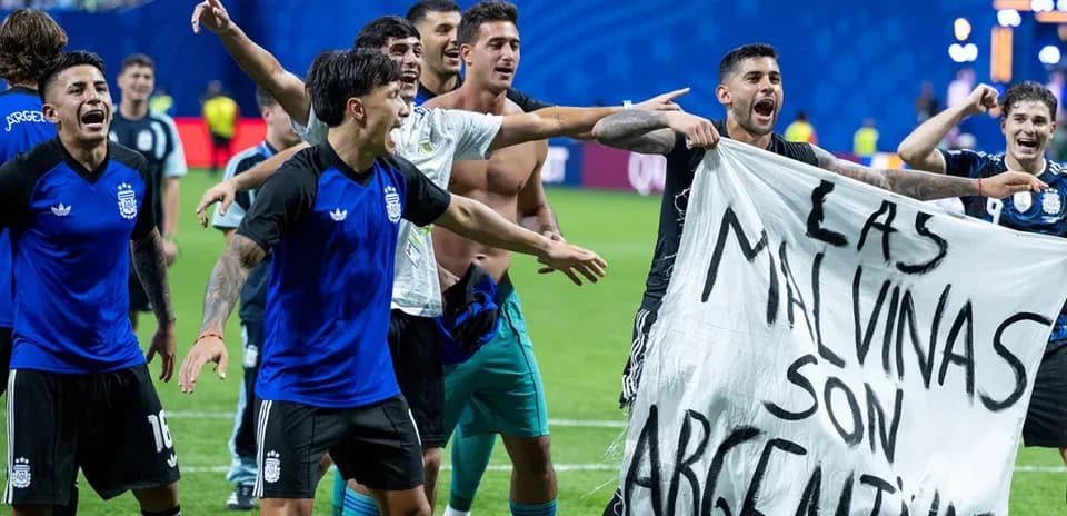 Argentina players celebrating with a banner on field