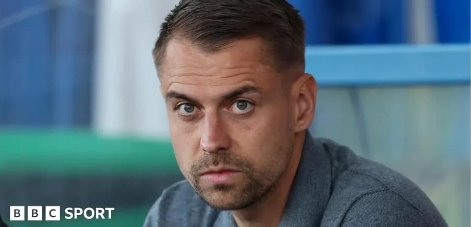 Man sitting in a stadium looking serious