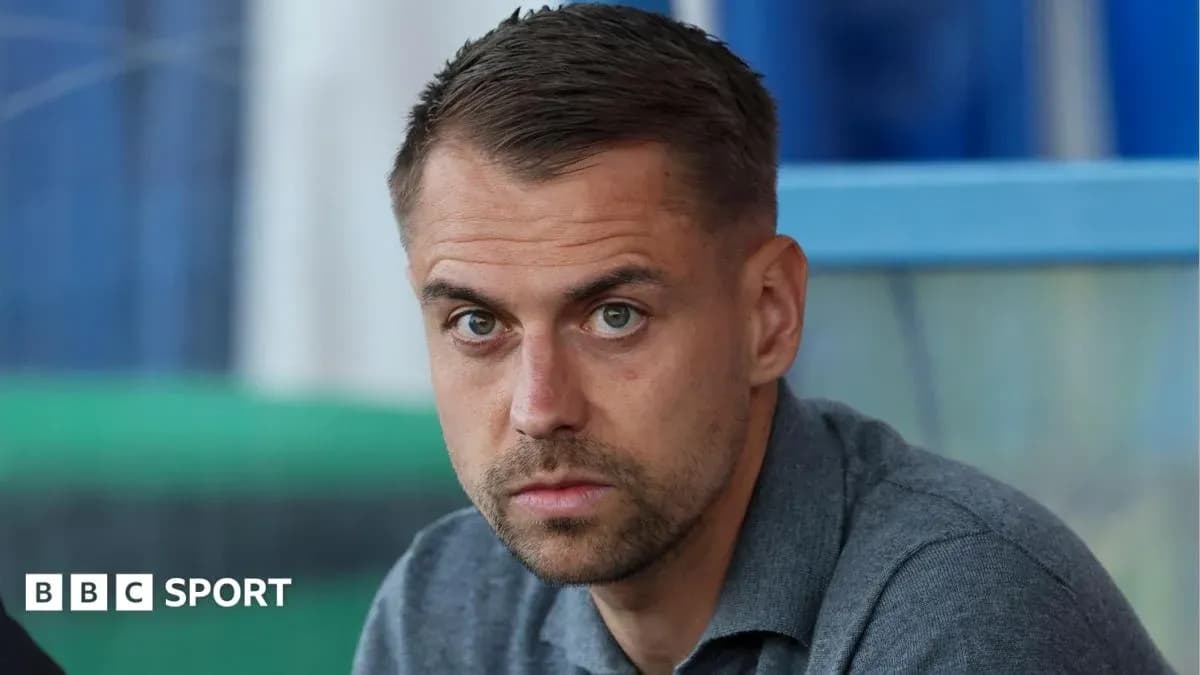 Man sitting in a stadium looking serious Man sitting in a stadium looking serious
