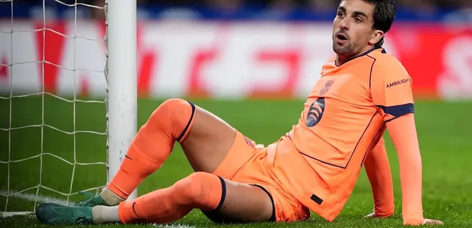 Goalkeeper sitting beside goalpost during match