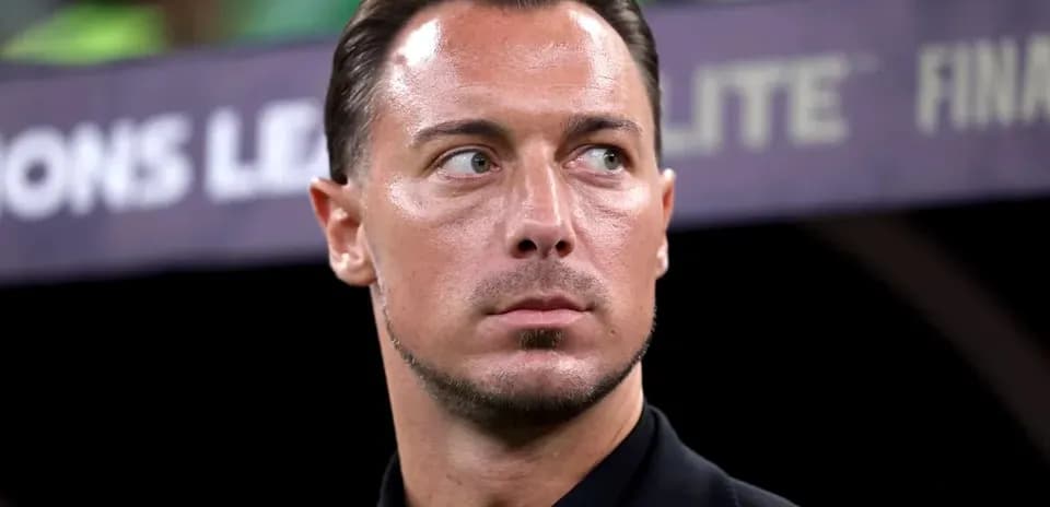 Men's football coach observing the match from sidelines